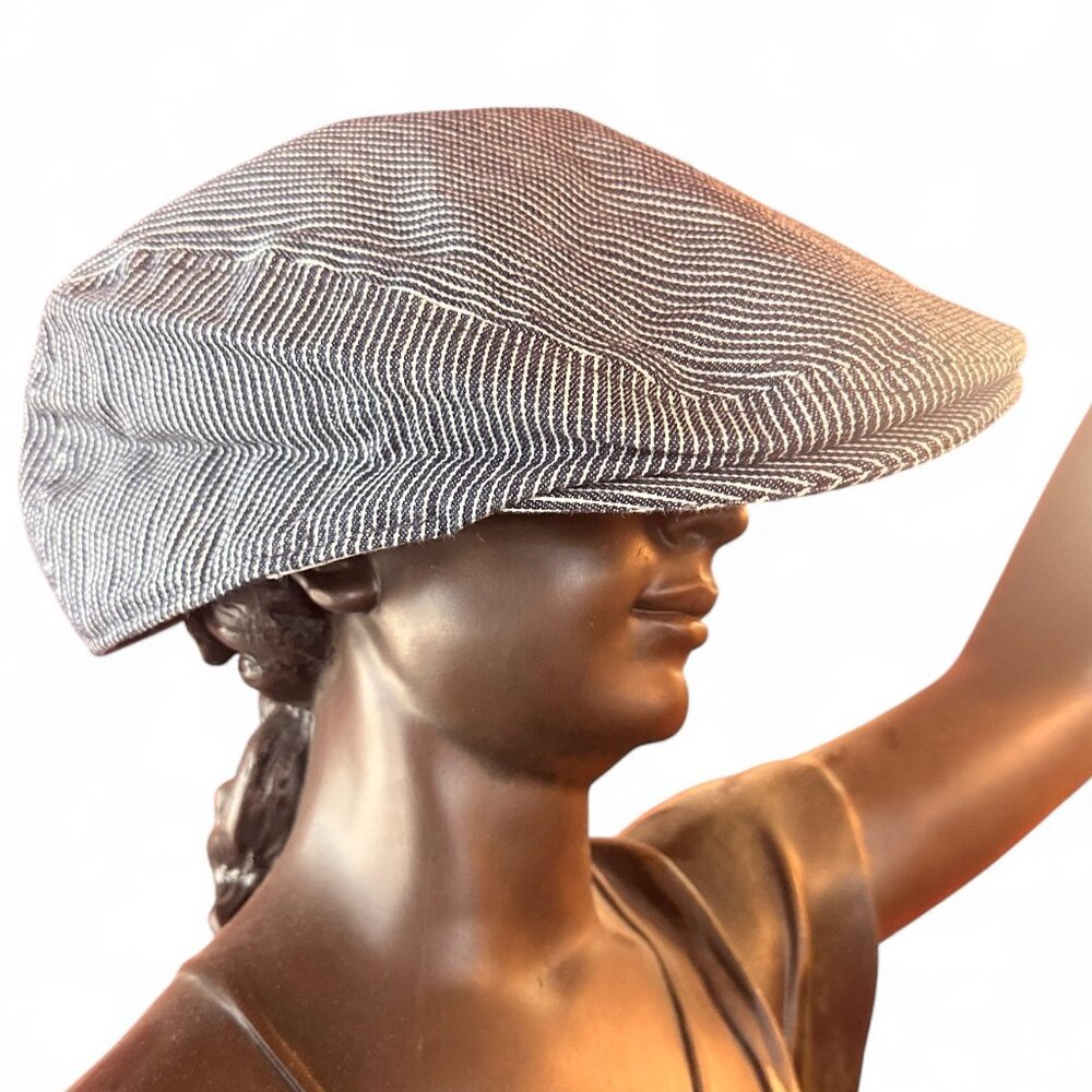 The Levi’s Denim Striped Newsboy Cap is a vintage style hat made from 100% cotto